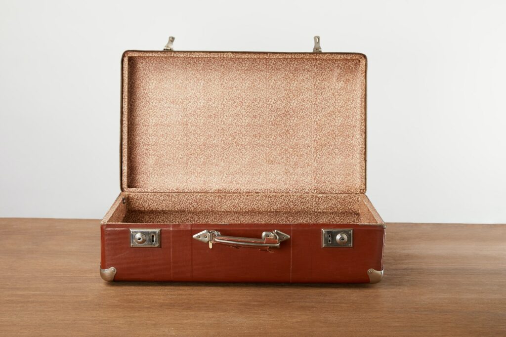 Open vintage suitcase on wooden table